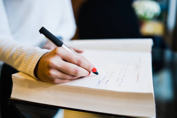 istock WOman writing in a Book 1072748408