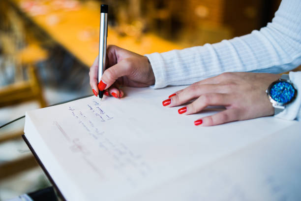 istock WOman writing in a Book 1072748754