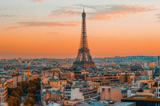 Eiffel Tower and Scenic View of the Paris Skyline during vibrant European Sunset Breathtaking view of the Eiffel Tower and the serene Paris skyline during a vibrant European sunset, captured from the top of the Arc de Triomphe. arc de triomphe paris photos stock pictures, royalty-free photos & images