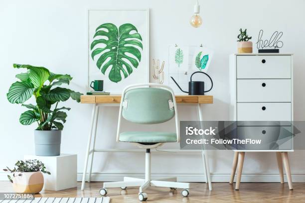 Stylish Scandinavian Home Office Desk With Mock Up Poster Frames A Lot Of Plants And Office Accessories Brown Wooden Parquet And White Backgrounds Wall Modern Composition Of Homeoffice Desk Stock Photo - Download Image Now