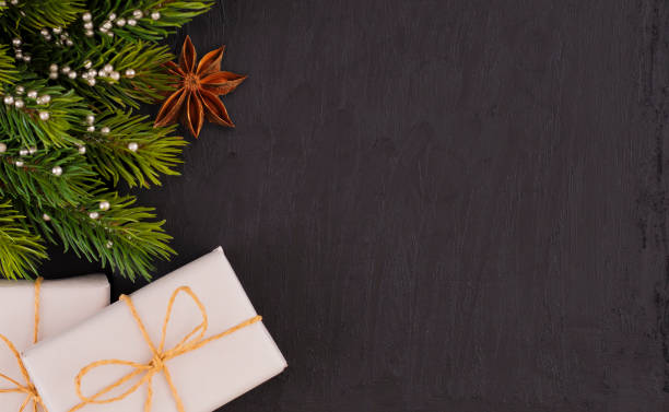 istock gift box and pine branch on the dark marble 1072752184