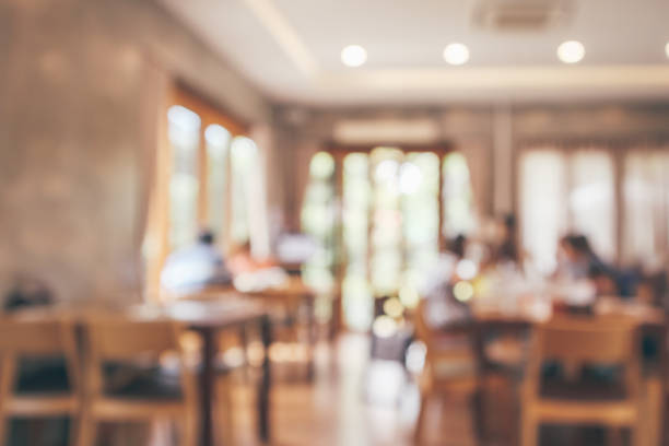 istock Restaurant interior with customer and wood table blur abstract background with bokeh light 1072753282