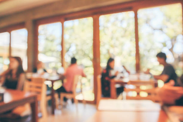 istock Restaurant cafe or coffee shop interior with customer blur abstract vintage style bokeh light for montage product display background 1072753564