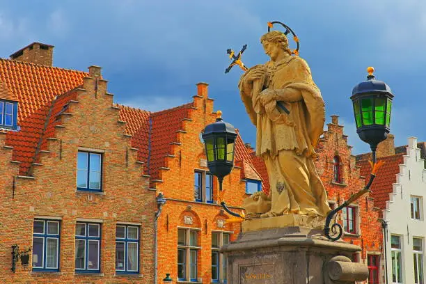 St John of Nepomuk monument against dramatic sky - Bruges medieval old town, Belgium