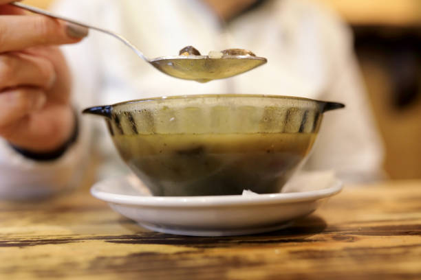 istock Person eating mushroom soup 1072758846