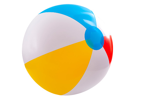 Summer vacation, beach toy and seaside fun activities concept with a inflatable beach ball isolated on white background with a clipping path cutout