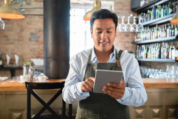 istock Waiter working at a restaurant holding the menu 1072788258