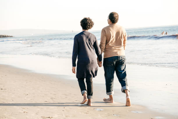 istock Senior couple walking on the beach 1072792702