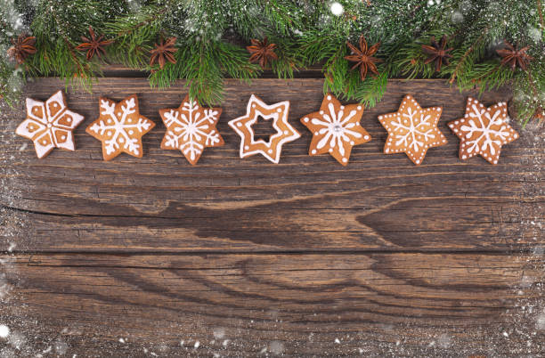 istock Christmas gingerbread snowflake star cookies and fire tree on rustic wood 1072793498