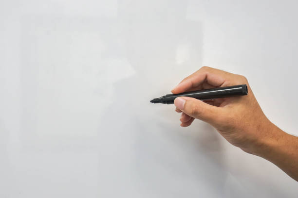 mock up whiteboard with man hand hold marker pen for writing stock photo