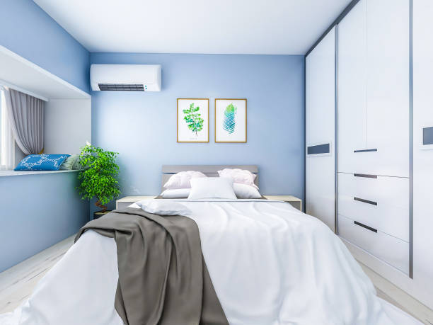 istock Spacious and unmanned bedroom design with solid wood custom closet and double bed in the blue walls, coffee table and decorations in front of the bed, TV, etc., green plants in the room 1072836220