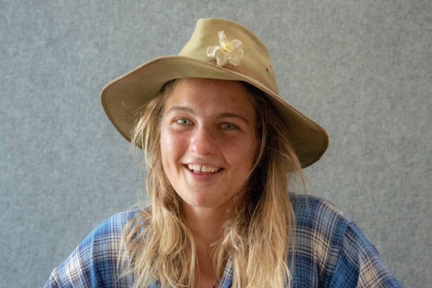 Attractive Australian young woman with hat smiling into camera.