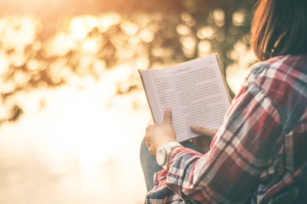 istock Women tourists read book in quiet nature. 1072840624