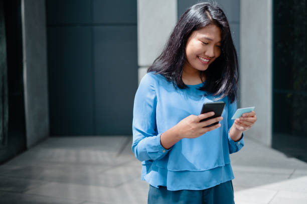 istock Young Asian Women Looking at Smartphone 1072853524