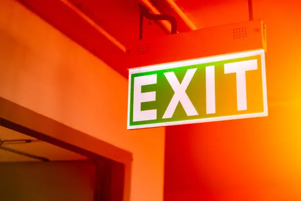 Photo of green fire exit sign light at emergency escape door