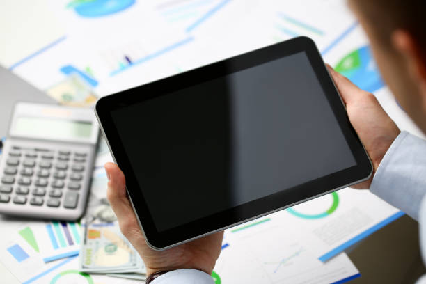 istock Businessman holds tablet on background 1072872148