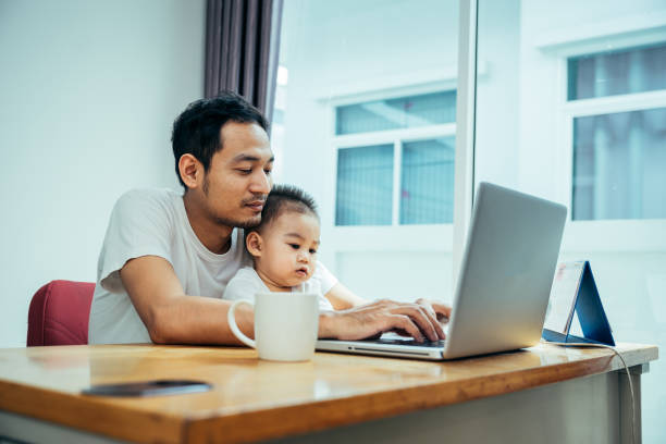 istock Asian father and his son is using the laptop computer 1072872460