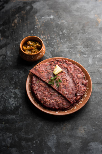 Ragi Roti made from finger millet from India is extremely rich in proteins served with pickle or achar. selective focus Ragi Roti made from finger millet from India is extremely rich in proteins served with pickle or achar. selective focus thosai stock pictures, royalty-free photos & images