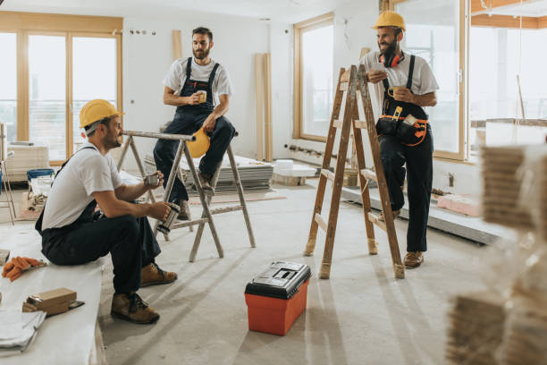 istock Team of happy manual workers talking on a coffee break at construction site. 1072902490