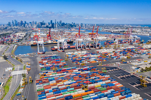 Melbourne, Australia - Nov 25, 2018: Aerial photo of the Port of Melbourne container terminal with Melbourne CBD in the background. It is Australia's busiest cargo port