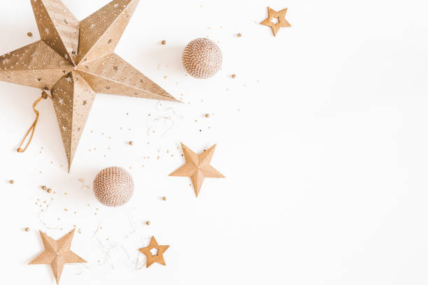 Christmas composition. Christmas golden decorations on white background. Flat lay, top view, copy space