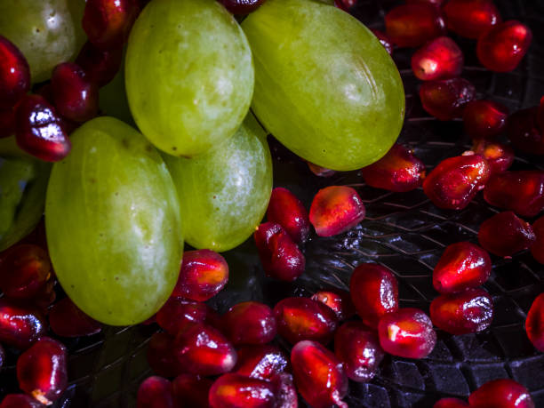 istock Pile of pomegranate and grapes. 1072914236