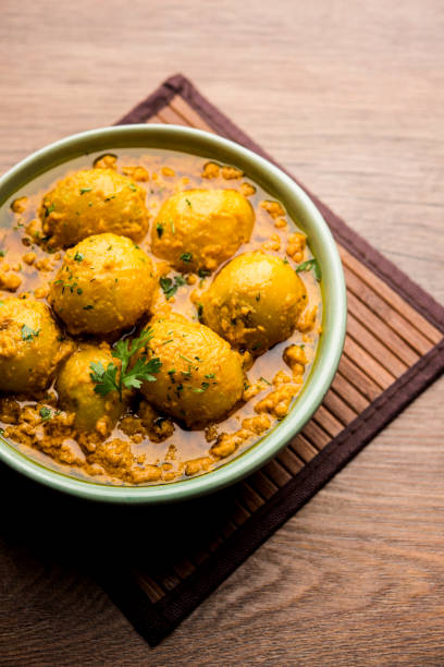 istock Indian Dum aloo curry using fried potatoes and spices, served in a bowl. selective focus 1072928888