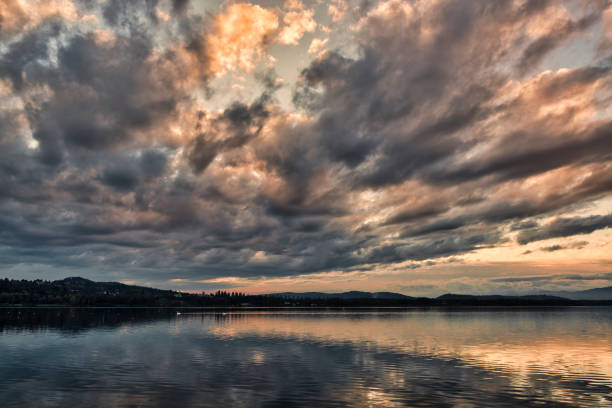 istock dark clouds at the sunset over the lake 1072928906