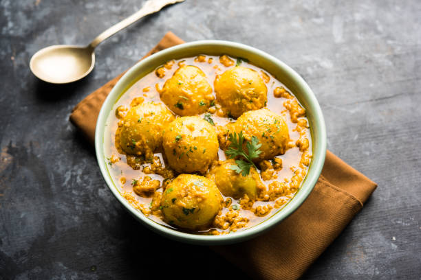 istock Indian Dum aloo curry using fried potatoes and spices, served in a bowl. selective focus 1072929830