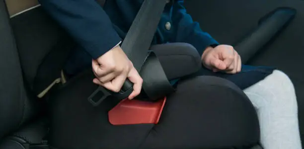 child-girl in a child seat, clips on independently, being in the car, before the trip