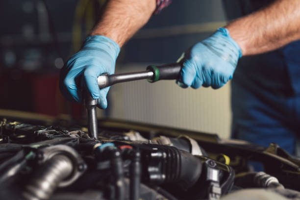 istock Auto mechanic working in garage. Repair service. 1072936632