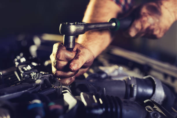 istock Auto mechanic working in garage. Repair service. 1072938310