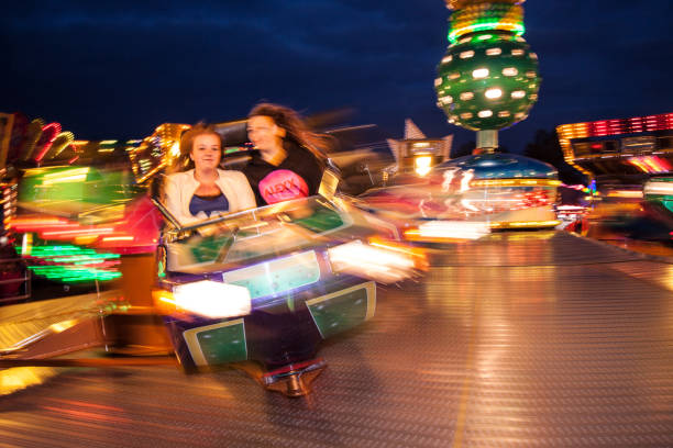 SOEST, THE NETHERLANDS, SEPTEMBER 2017. People enjoying a ride in an ultra fast spinning octopus ride at a fair. With motion blur, bursts of light and firework.