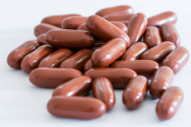 istock red brown large vitamin pills on a white background 1072943494