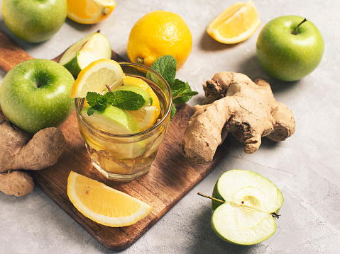 ginger detox and diet drink with lemon and apple on white background