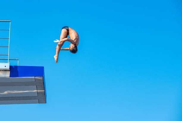 young man diving against clear sky - shirtless energy action effort imagens e fotografias de stock
