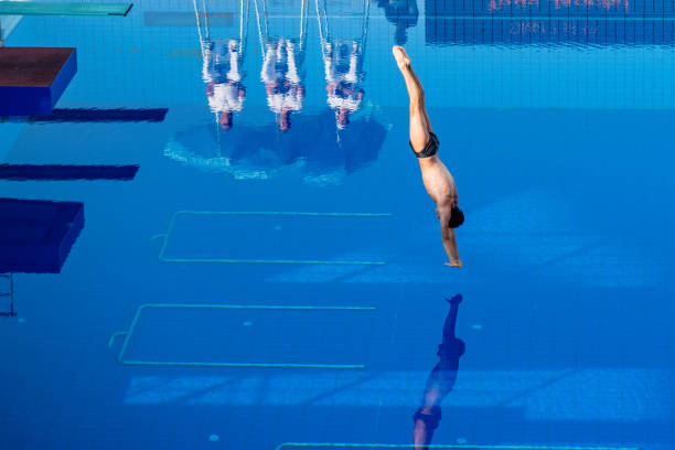istock Young man diving in swimming pool 1072946800