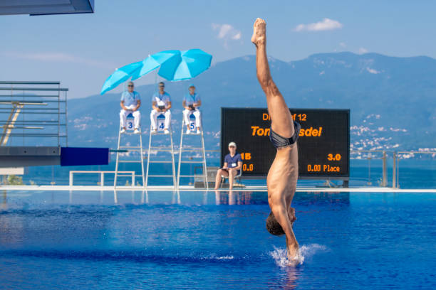 male diver diving in the swimming pool - shirtless energy action effort imagens e fotografias de stock