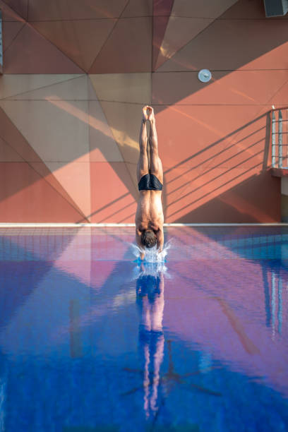 rear view of young man diving - shirtless energy action effort imagens e fotografias de stock