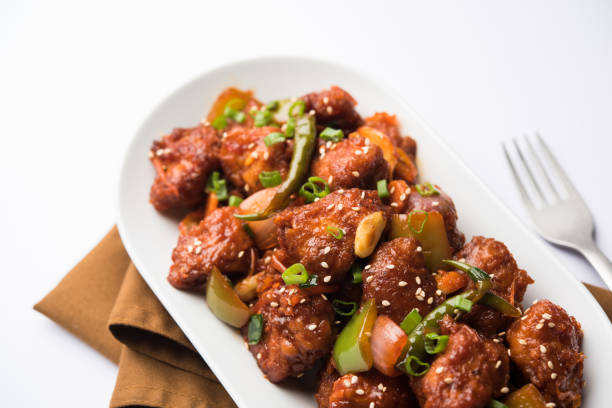 istock Indian Chilli Chicken dry, served in a plate over moody background. Selective focus 1072949602