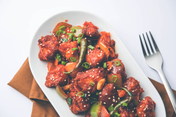 istock Indian Chilli Chicken dry, served in a plate over moody background. Selective focus 1072949612