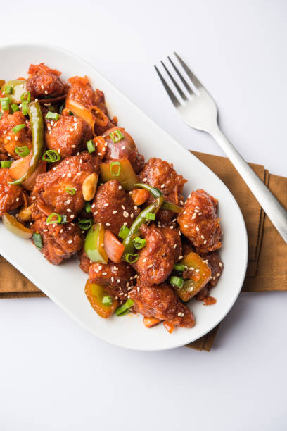 istock Indian Chilli Chicken dry, served in a plate over moody background. Selective focus 1072949622