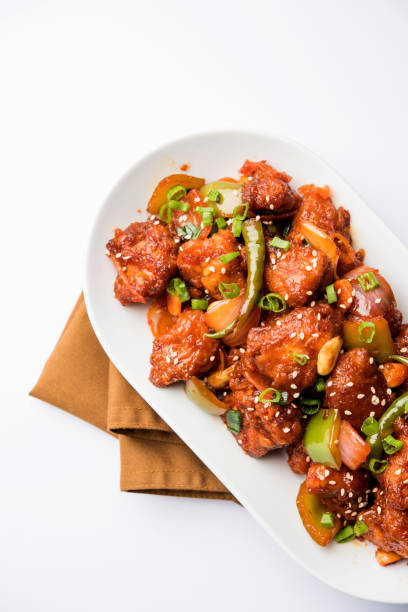 istock Indian Chilli Chicken dry, served in a plate over moody background. Selective focus 1072949638