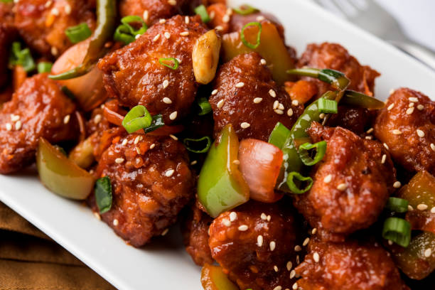 istock Indian Chilli Chicken dry, served in a plate over moody background. Selective focus 1072949652