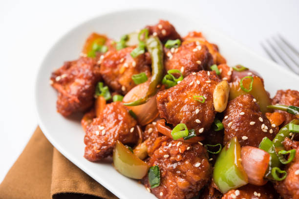 istock Indian Chilli Chicken dry, served in a plate over moody background. Selective focus 1072949670