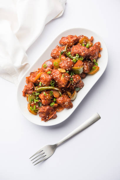 istock Indian Chilli Chicken dry, served in a plate over moody background. Selective focus 1072949968