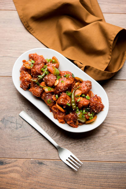 istock Indian Chilli Chicken dry, served in a plate over moody background. Selective focus 1072950904