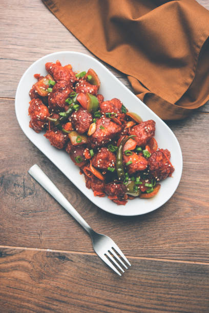 istock Indian Chilli Chicken dry, served in a plate over moody background. Selective focus 1072950958