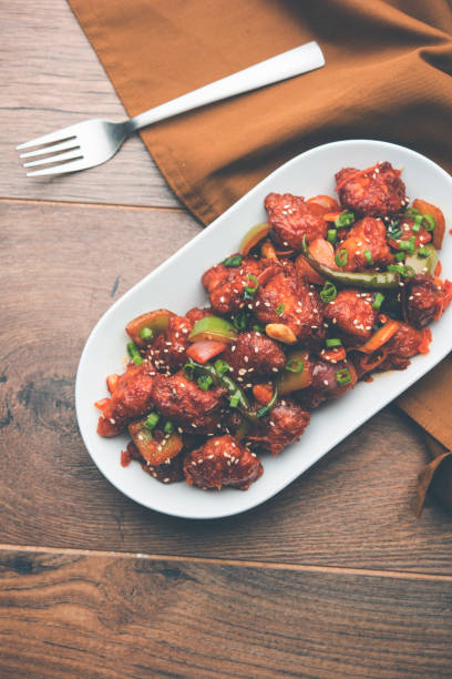 istock Indian Chilli Chicken dry, served in a plate over moody background. Selective focus 1072951334
