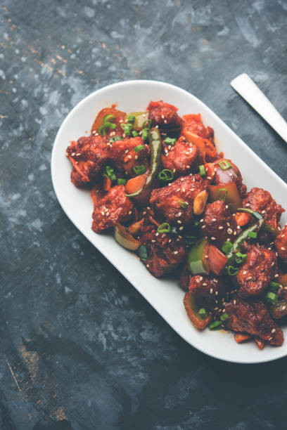 istock Indian Chilli Chicken dry, served in a plate over moody background. Selective focus 1072951708